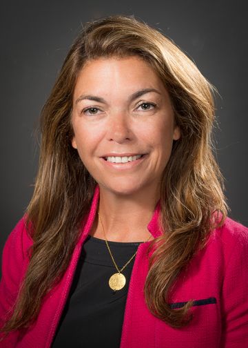 Elaine Brennan wearing a black shirt and pink jacket
